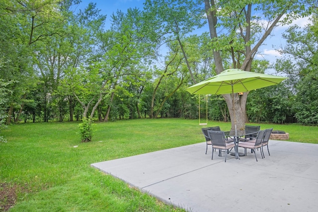 view of yard featuring an outdoor fire pit and a patio area