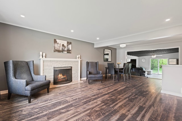 living area featuring recessed lighting, a fireplace, crown molding, and wood finished floors