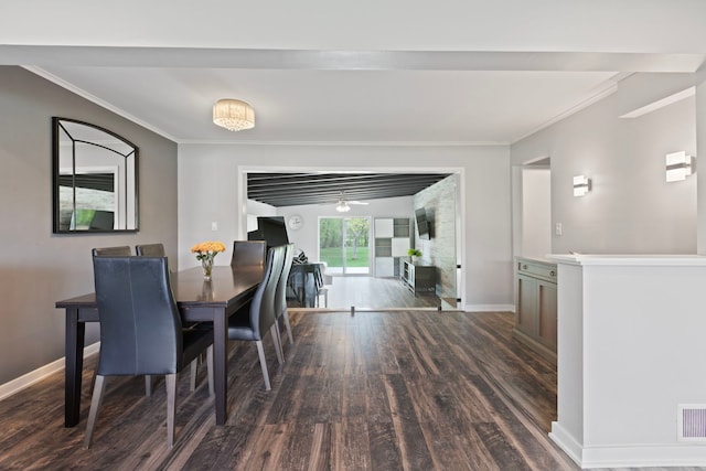 dining room featuring baseboards, dark wood finished floors, and crown molding