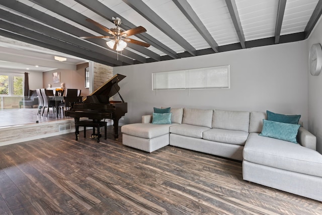 living area with a ceiling fan, visible vents, beam ceiling, and wood finished floors