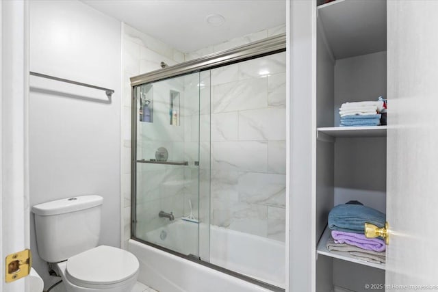 full bath featuring bath / shower combo with glass door and toilet