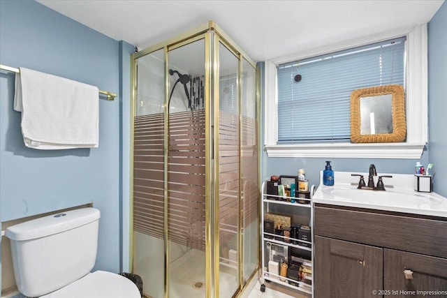 full bath featuring vanity, a shower stall, and toilet