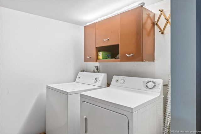 washroom featuring cabinet space and washer and dryer