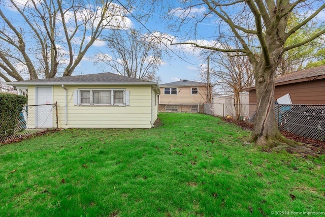 back of house featuring fence and a yard