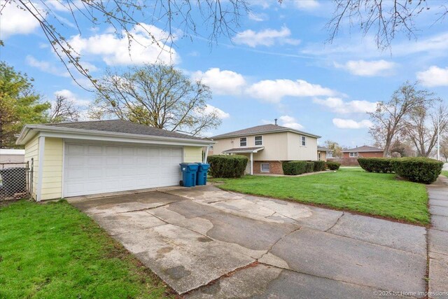view of side of home with a lawn, a detached garage, and an outdoor structure