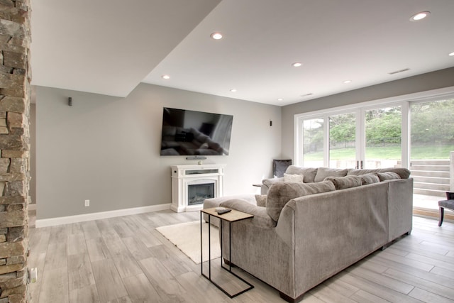 4432 Bryant Dr, Quincy, IL 62305 - living area featuring light wood-type flooring, recessed lighting, baseboards, and a glass covered fireplace