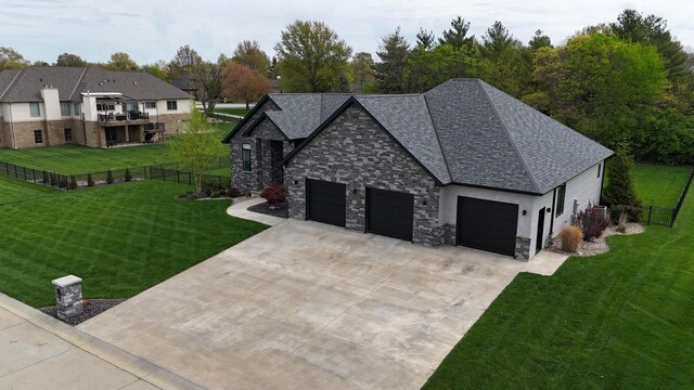4432 Bryant Dr, Quincy, IL 62305 - view of side of home with fence, a yard, an attached garage, and stone siding