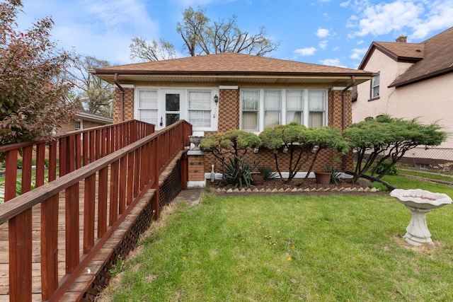 420 N Hebbard St, Joliet, IL 60432 - back of house with a yard, brick siding, and a shingled roof