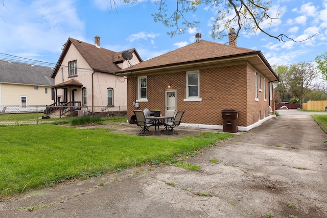 420 N Hebbard St, Joliet, IL 60432 - back of property featuring a chimney, brick siding, roof with shingles, and a patio area
