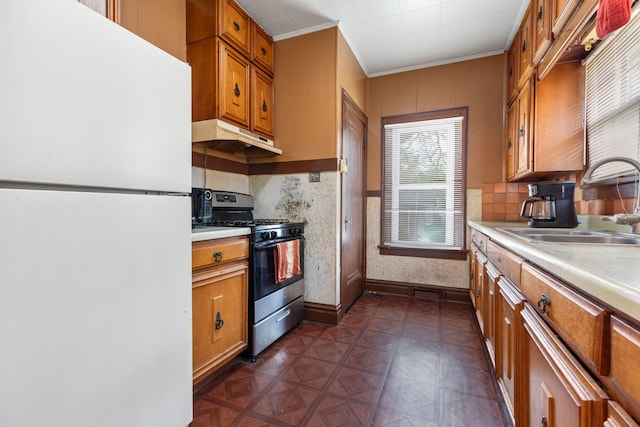 420 N Hebbard St, Joliet, IL 60432 - kitchen with freestanding refrigerator, stainless steel gas stove, light countertops, ornamental molding, and brown cabinetry