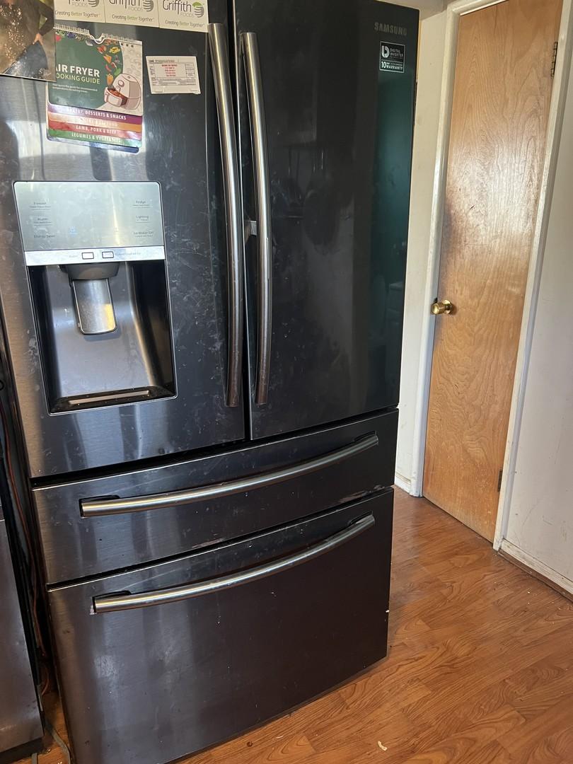 410 Gettysburg St, Park Forest, IL 60466 - detailed view of refrigerator with ice dispenser, wood finished floors, and baseboards