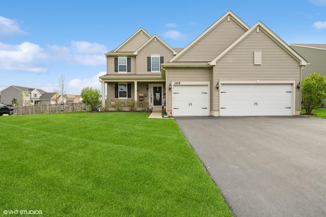view of front facade with fence, driveway, a front lawn, and a garage