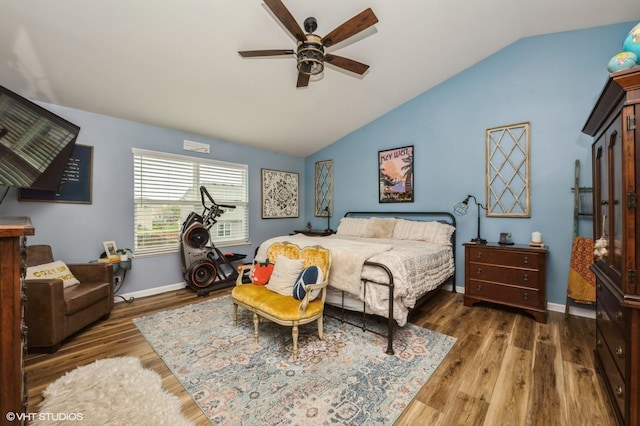bedroom with wood finished floors, a ceiling fan, baseboards, and lofted ceiling