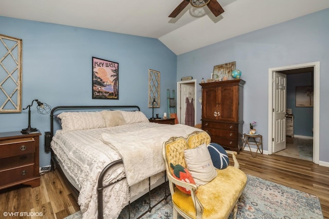 bedroom featuring baseboards, a ceiling fan, wood finished floors, and lofted ceiling