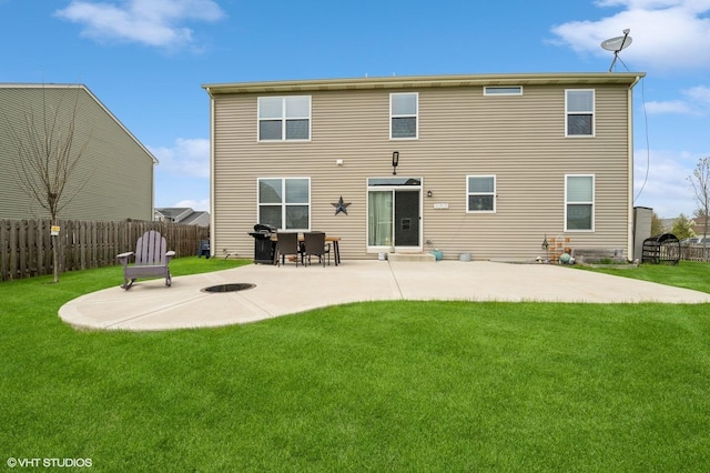 rear view of house featuring a lawn, a patio area, and fence