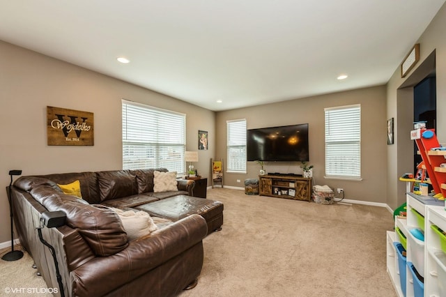 carpeted living area featuring baseboards and recessed lighting