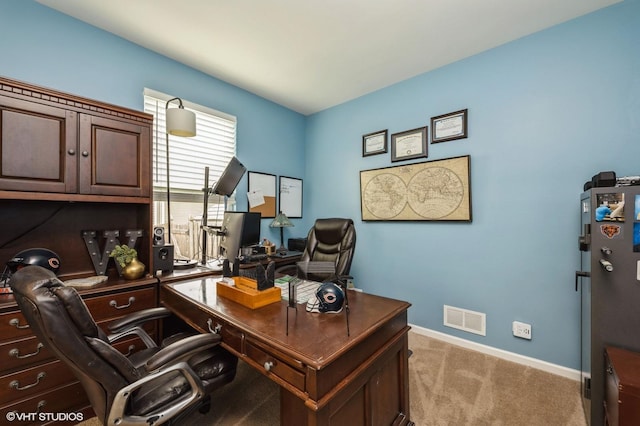 office featuring light colored carpet, baseboards, and visible vents