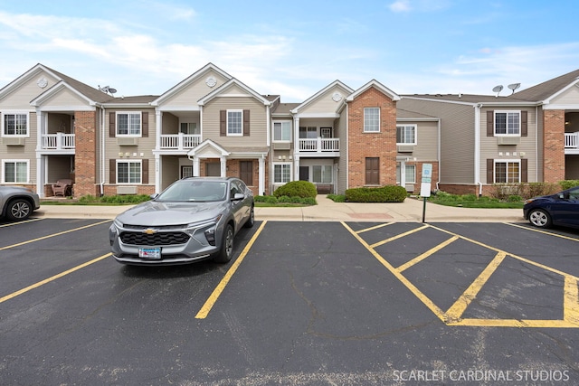 uncovered parking lot with a residential view