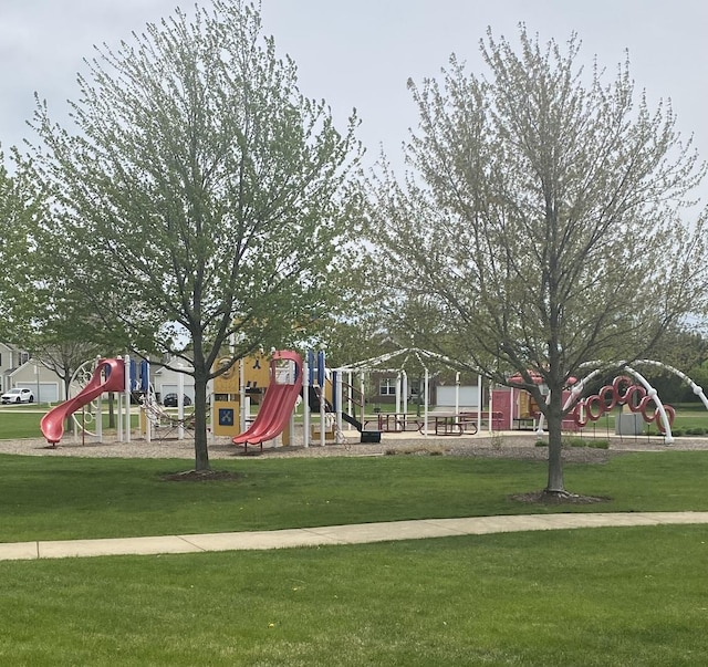 community jungle gym featuring a yard