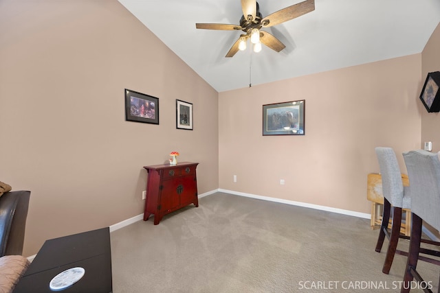 office area with a ceiling fan, baseboards, vaulted ceiling, and carpet