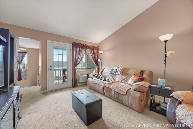 carpeted living room with a wall unit AC and lofted ceiling