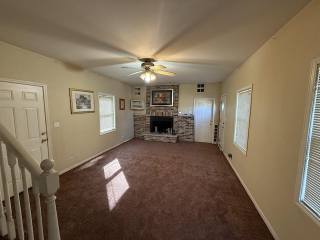 14500 Sawyer Ave, Midlothian, IL 60445 - unfurnished living room featuring carpet floors, visible vents, a brick fireplace, baseboards, and a ceiling fan