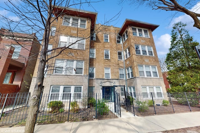 view of building exterior with a fenced front yard