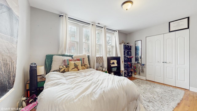 bedroom featuring wood finished floors and a closet