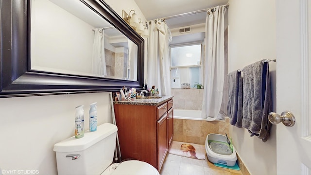 bathroom with visible vents, tile patterned flooring, vanity, tiled shower / bath, and toilet