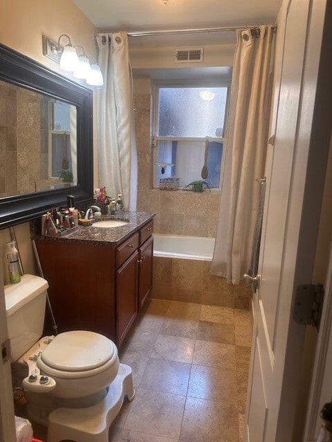 2452 N Lawndale Ave Unit G, Chicago, IL 60647 - bathroom featuring toilet, vanity, tile patterned floors, and tiled shower / bath combo
