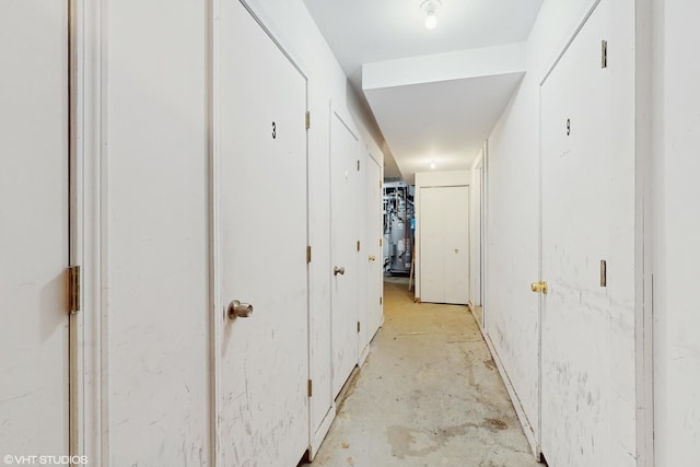 corridor with unfinished concrete floors