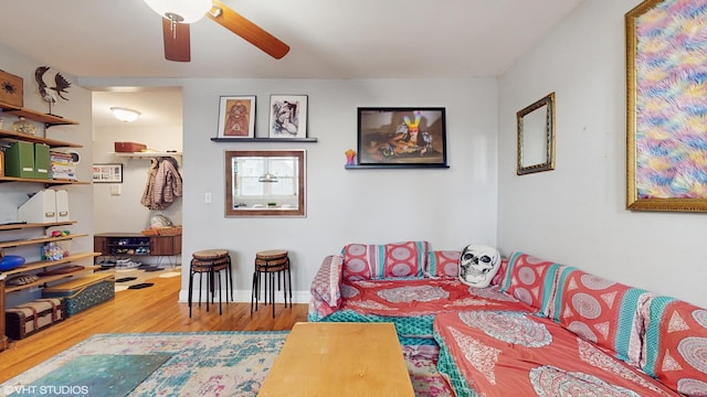 living area featuring ceiling fan and wood finished floors