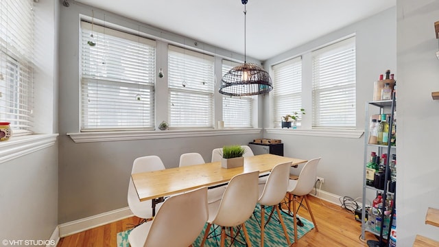 dining area featuring baseboards and wood finished floors