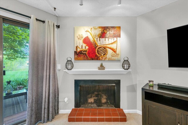 interior details featuring baseboards, carpet flooring, a textured ceiling, and a tile fireplace