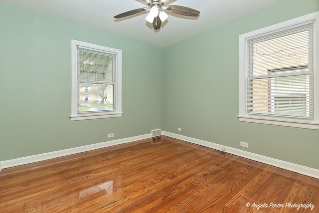 unfurnished room with visible vents, a ceiling fan, baseboards, and a healthy amount of sunlight