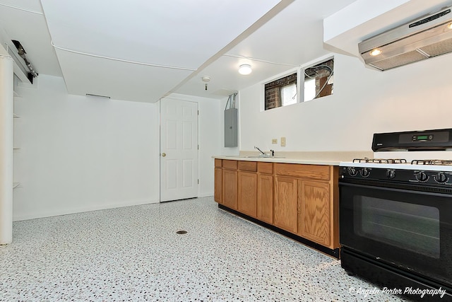 kitchen with exhaust hood, light countertops, brown cabinetry, black range with gas cooktop, and electric panel