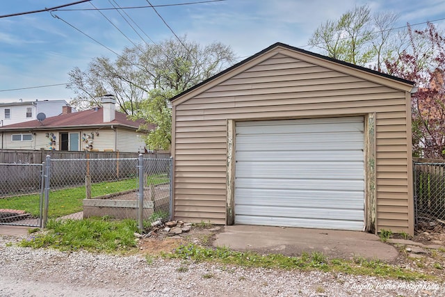 detached garage featuring fence