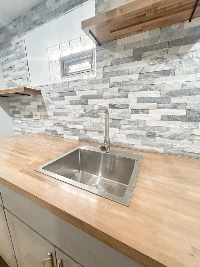 details with wood finished floors and a glass covered fireplace