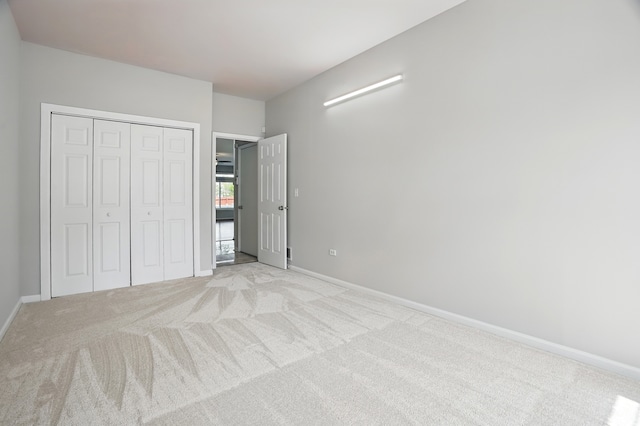 122 Periwinkle Ln, Bolingbrook, IL 60490 - unfurnished bedroom with light colored carpet, a closet, and baseboards
