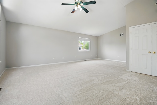 122 Periwinkle Ln, Bolingbrook, IL 60490 - spare room with vaulted ceiling, a ceiling fan, light colored carpet, and baseboards