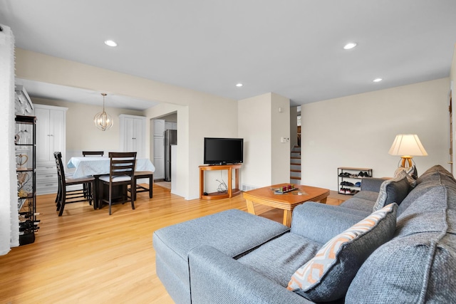 living area featuring a chandelier, recessed lighting, and light wood finished floors