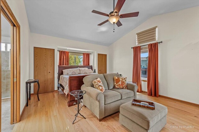 bedroom with vaulted ceiling, light wood-type flooring, ceiling fan, and baseboards