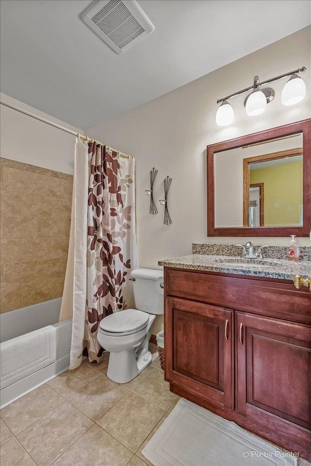 full bath featuring toilet, tile patterned floors, vanity, and shower / tub combo