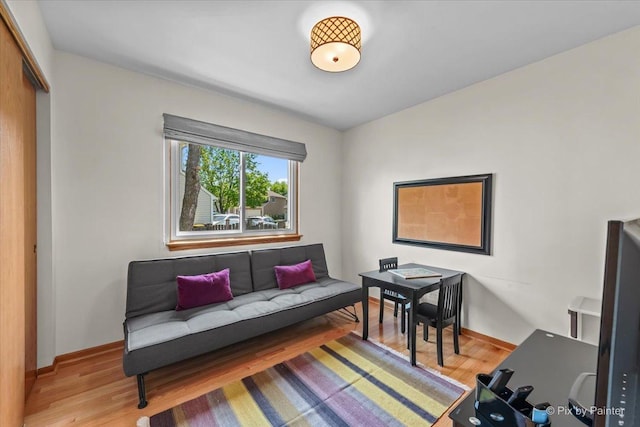 living area with wood finished floors and baseboards