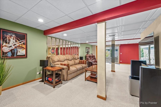 carpeted living area with baseboards, a drop ceiling, and recessed lighting