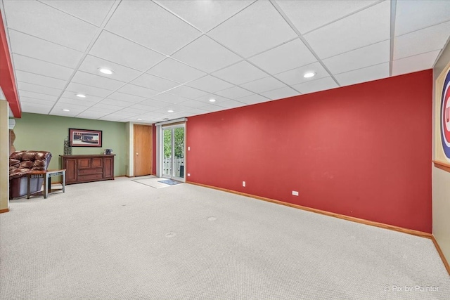 carpeted spare room featuring baseboards, recessed lighting, and a drop ceiling