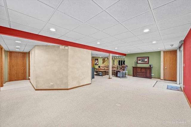 finished below grade area featuring carpet floors, a paneled ceiling, baseboards, and recessed lighting