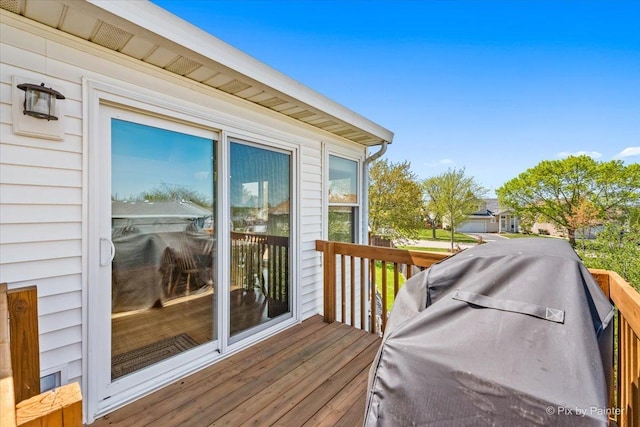 wooden terrace featuring a grill