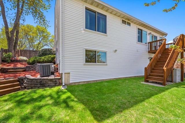 back of house with central AC, a wooden deck, and stairs