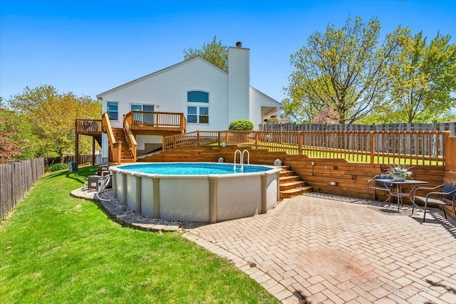view of swimming pool with stairs, a wooden deck, and a patio area